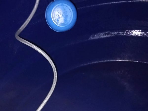 Interior de caixa d'água com boia e conexão de entrada recém-instaladas