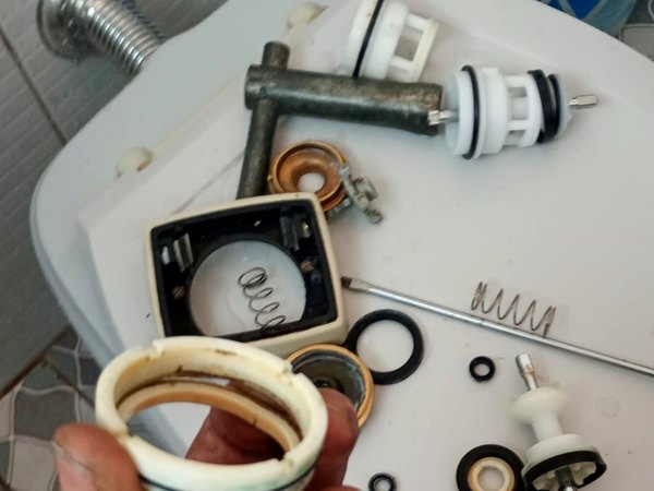 Peças de válvula Hydra desmontadas, com o reparo desgastado ao lado da peça nova